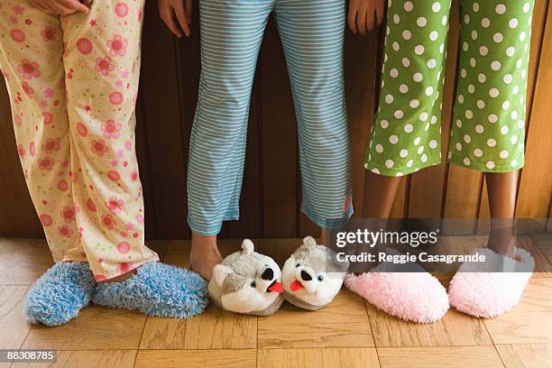 pre-teen girls wearing fuzzy slippers - kid slippers stock pictures, royalty-free photos & images