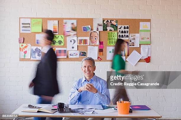 calm businessman in busy office - incidental people stock pictures, royalty-free photos & images
