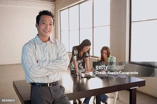 smiling businessman and businesswomen in meeting - native korean stock-fotos und bilder