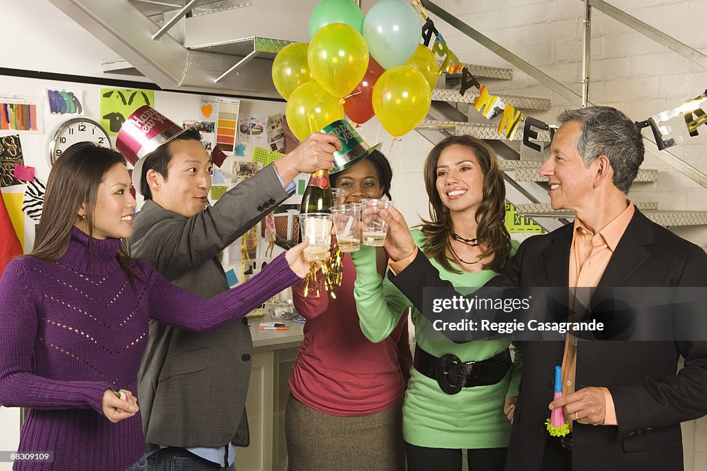 Co-workers in office having a New Year's Eve party