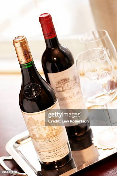 bottles of french red wine - bordeaux bottle stock pictures, royalty-free photos & images