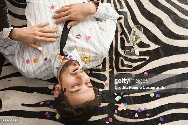 man with hangover on new year's day - men of the year party inside stock pictures, royalty-free photos & images