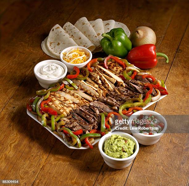 fajitas with condiments - mexican food plate stock pictures, royalty-free photos & images