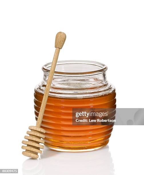 honey jar and dipper - honey stockfoto's en -beelden