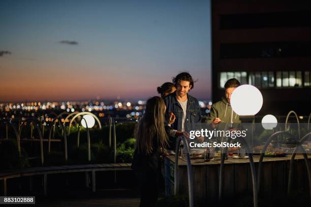 rooftop party after dark - rooftop at night stock pictures, royalty-free photos & images