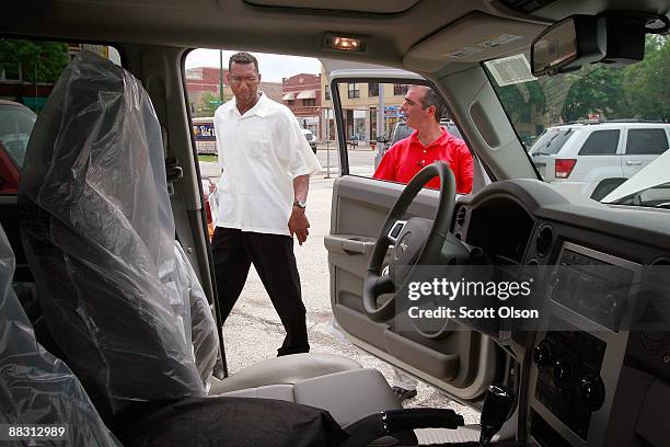 Salesman Sam Zayed helps Jeffrey Turner as he shops for a Jeep at Premier Chrysler June 8, 2009 in Chicago, Illinois. The dealership is 1 of the 789...