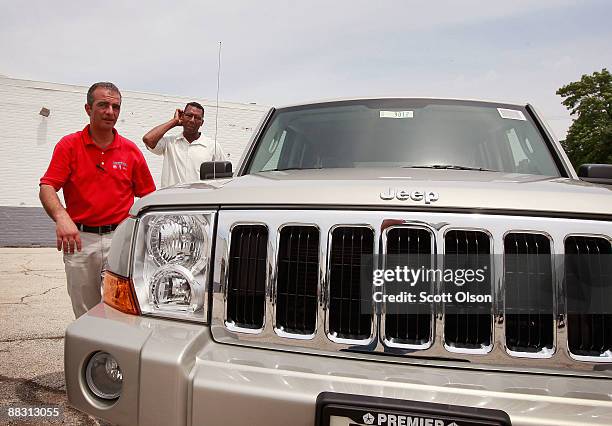 Salesman Sam Zayed helps Jeffrey Turner as he shops for a Jeep at Premier Chrysler June 8, 2009 in Chicago, Illinois. The dealership is 1 of the 789...