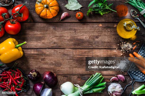 frame of assorted fresh vegetables on rustic wooden table - food on table stock pictures, royalty-free photos & images