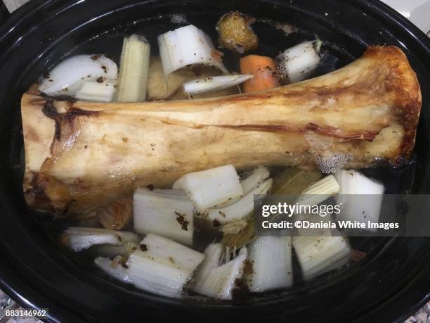 making beef bone broth - bone broth stock pictures, royalty-free photos & images