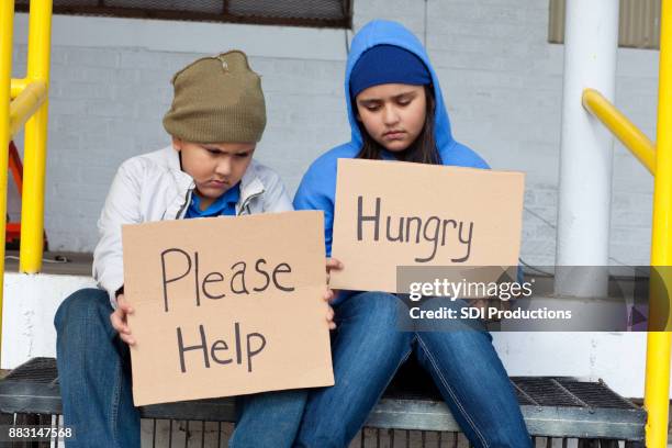 young brother and sister beg on the street - hungry teen stock pictures, royalty-free photos & images