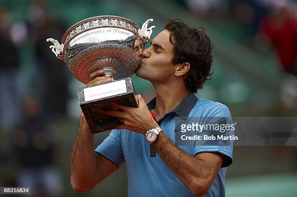 Switzerland Roger Federer victorious, kissing Coupe des Mousquetaires trophy during award ceremony after winning Men's Final vs Sweden Robin...