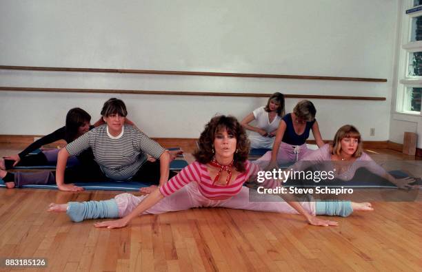 Along with unidentified others, American actress Jane Fonda exercises during a photo shoot for 'Jane Fonda's Workout Book,' Los Angeles, California,...