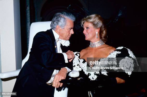 View of American actors John Forsythe and Linda Evans on the set of the television series 'Dynasty,' 1980s.