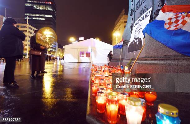 People light candles in tribute to General Slobodan Praljak in Zagreb on November 30 after the Bosnian Croat war criminal took his own life in front...