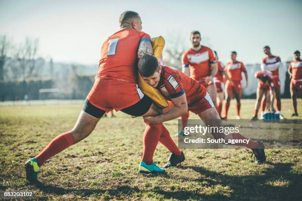 rugby players doing warm up exercises - scrum roles stock pictures, royalty-free photos & images