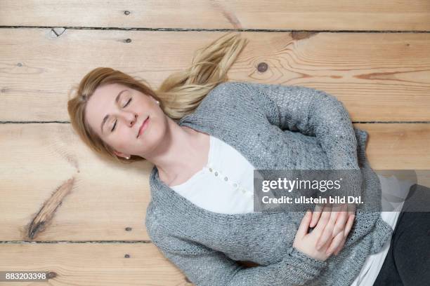 Frau ruht sich auf Holzboden aus