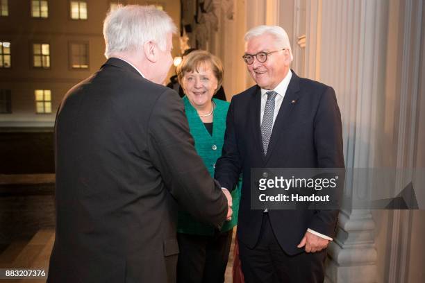 In this handout photo provided by the German Government Press Office , German President Frank-Walter Steinmeier greets Horst Seehofer , Governor of...