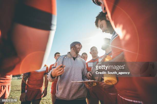 coach talking to players during time out - rugby sport stock pictures, royalty-free photos & images