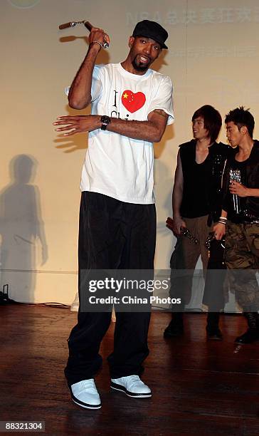 Player for the Detroit Pistons Richard Hamilton plays Nunchaku in a party during which people watch the live broadcast of 2009 NBA Playoffs Finals -...