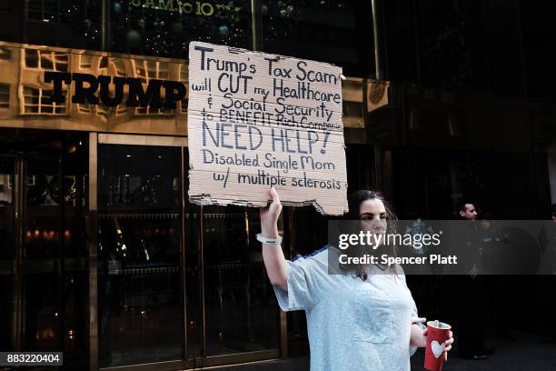 Rosary Solimanto, who has multiple sclerosis and fears for her finances, holds a protest outside of Trump Tower over the Republican administration's...