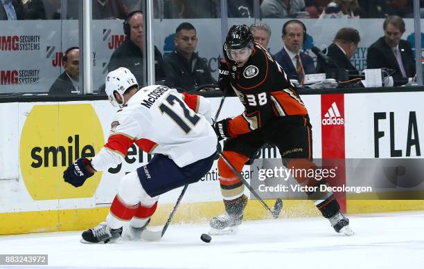 Derek Grant of the Anaheim Ducks and Ian McCoshen of the Florida Panthers vie for the puck during the NHL game at Honda Center on November 19, 2017...