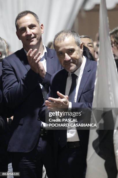 Pe a Corsica nationalist party candidates for Corsican regional elections Gilles Simeoni and Jean-Guy Talamoni clap behind a Corsican flag during a...