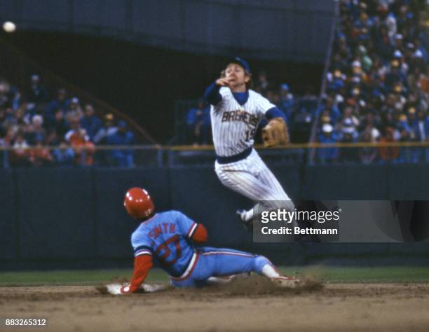 The St. Louis Cardinals Lonnie Smith slides into second base as the Milwaukee Brewers Robin Yount throws the ball after tagging Smith out during the...