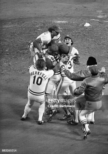 St. Louis Cardinal team mobs pitcher, Bruce Sutter, at the end of the World Series am. St. Louis won the World Series and defeated Milwaukee 6-3 in...