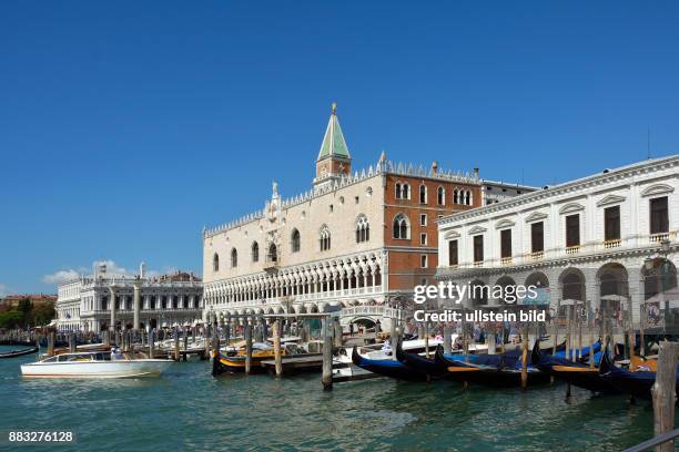 View from the waterfront Riva degli Schiavoni with tourists at the Doge?s Palace and Campanile of Venice in Italy.