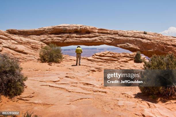 taking a picture of mesa arch - navajo sandstone formations stock pictures, royalty-free photos & images