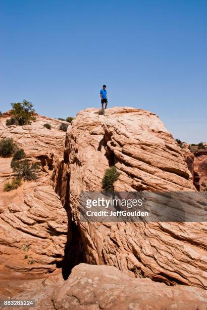 walking across mesa arch - navajo sandstone formations stock pictures, royalty-free photos & images