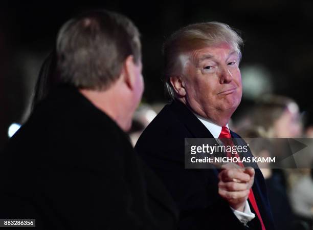 President Donald Trump, speaks with US Secretary of the Interior Ryan Zinke during the 95th annual National Christmas Tree Lighting ceremony at the...
