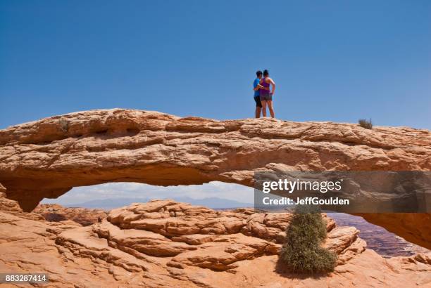 standing on mesa arch - navajo sandstone formations stock pictures, royalty-free photos & images