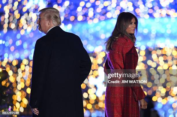 President Donald Trump and First Lady Melania Trump walk on the stage during the 95th annual National Christmas Tree Lighting ceremony at the Ellipse...