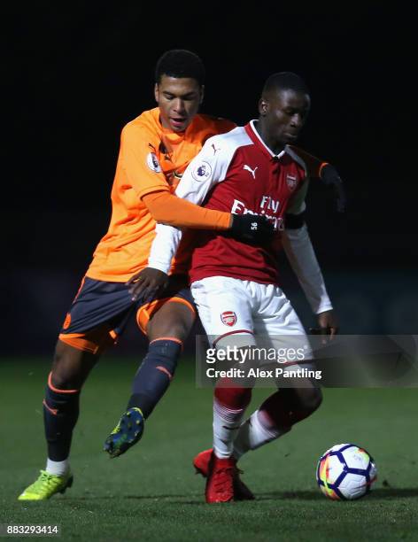Jordi Osei-Tutu of Arsenal and Danny Loader of Reading battle for posession during the Premier League International Cup match between Arsenal and...