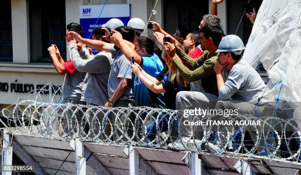 Supporters of Brazils Gremio footballers cheer their team upon its arrival after winning the Copa Libertadores 2017, on November 30 in Porto Alegre,...