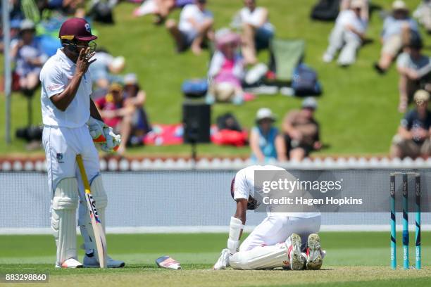 Kraigg Brathwaite of the West Indies reacts after being struck by a delivery while teammate Kieran Powell looks on during day one of the Test match...