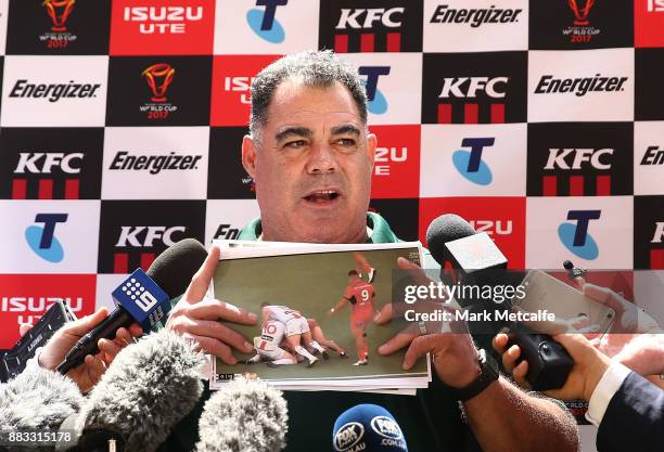 Australia coach Mal Meninga shows photos to media before an Australian Kangaroos training session at Suncorp Stadium on December 1, 2017 in Brisbane,...