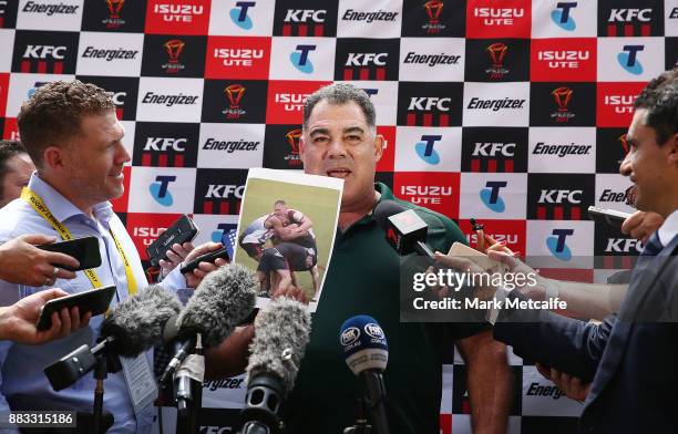 Australia coach Mal Meninga shows photos to media before an Australian Kangaroos training session at Suncorp Stadium on December 1, 2017 in Brisbane,...