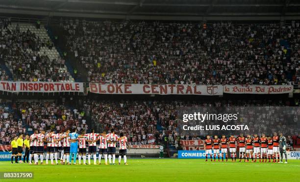 Colombia's Junior and Brazil's Flamengo players hold a minute of silence in honour of the victims and survivors of Lamia flight 2933 - two days after...