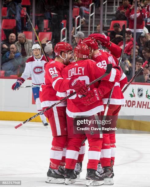 Anthony Mantha of the Detroit Red Wings celebrates his first period goal with teammates Trevor Daley and Xavier Ouellet during an NHL game against...