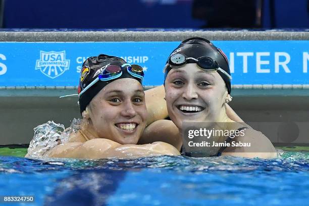 Mallory Comerford of the University of Louisville, left, and Kelsi Worrell of Cardinal Aquatic embrace after the Women's 50 Yard Freestyle Final...