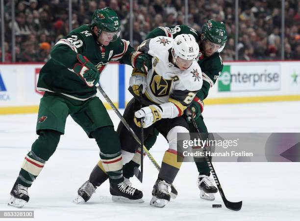 November 30: Cody Eakin of the Vegas Golden Knights loses the puck against Ryan Suter and Jason Zucker of the Minnesota Wild during the first period...