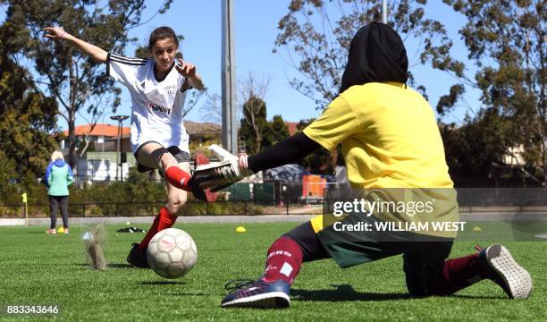 Photo taken on September 14 shows youths in action during a football match organised by Football United, a programme helping refugees integrate in...