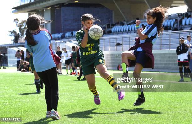 Photo taken on September 14 shows youths in action during a football match organised by Football United, a programme helping refugees integrate in...