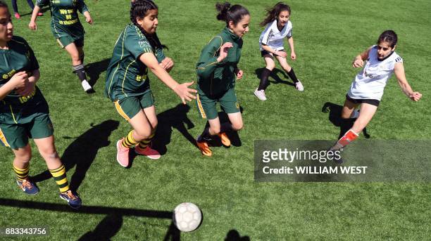 Photo taken on September 14 shows youths in action during a football match organised by Football United, a programme helping refugees integrate in...