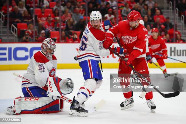 Carey Price of the Montreal Canadiens makes a second period save behind teammate Jeff Petry and Tomas Tatar of the Detroit Red Wings at Little...