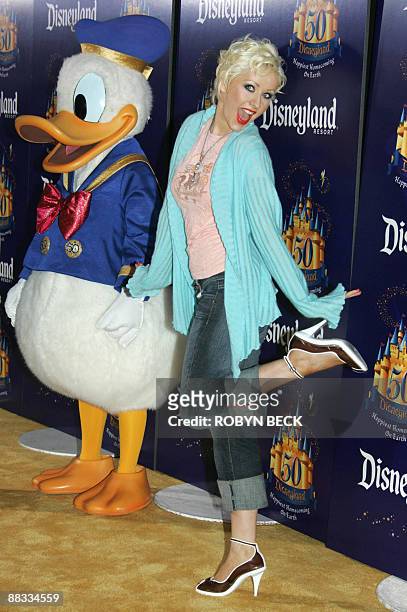 This May 4, 2005 file photo shows US singer Christina Aguilera arriving with Disney character Donald Duck for Disneyland's 50th anniversary party at...