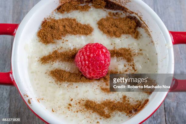 Rice pudding dessert or sweet food. The dish is made from rice mixed with milk and other ingredients such as cinnamon, raspberry and raisins.