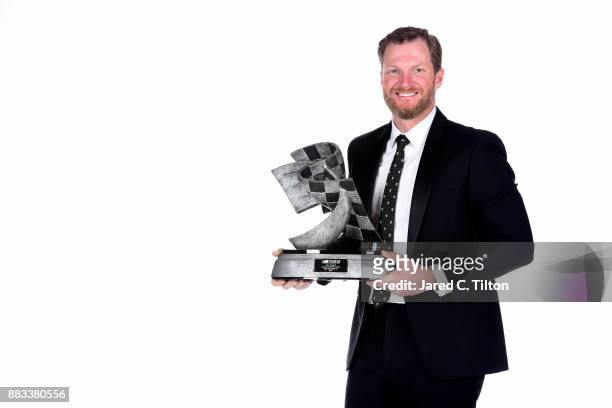 Driver Dale Earnhardt Jr. Poses with The Bill France Award of Excellence following the Monster Energy NASCAR Cup Series awards at Wynn Las Vegas on...